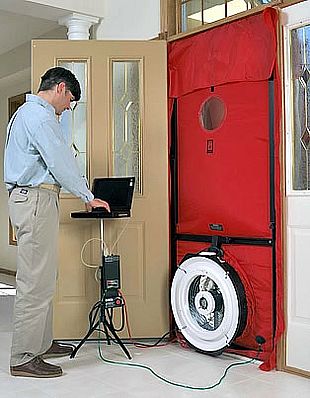 Technician setting up a red blower door in a home's front doorway.