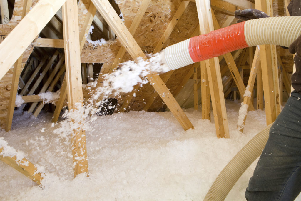 Loose-fill insulation being blown into an attic